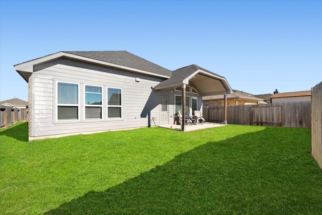 4430 Painted Bunting Ln, Baytown, TX 77521 - rear view of house featuring a patio, a shingled roof, a fenced backyard, and a lawn
