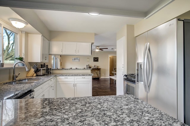 5522 Duxbury St, Houston, TX 77035 - kitchen featuring stainless steel appliances, a sink, dark wood-style flooring, and light stone countertops
