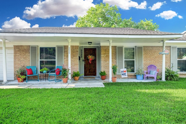 5522 Duxbury St, Houston, TX 77035 - property entrance with a porch, brick siding, a lawn, and a shingled roof