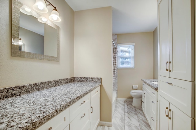 5522 Duxbury St, Houston, TX 77035 - bathroom with marble finish flooring, vanity, toilet, and baseboards