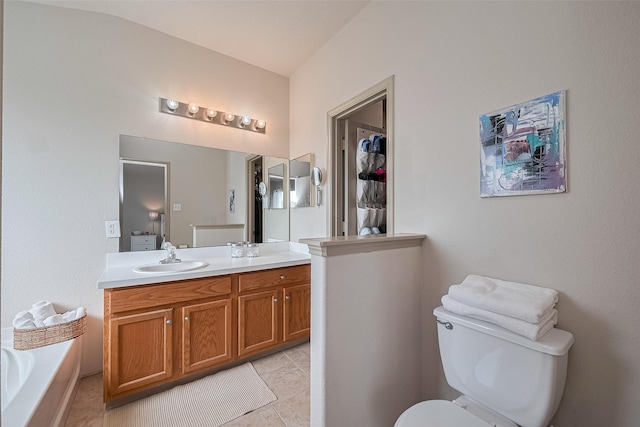 full bathroom featuring vanity, tile patterned flooring, a garden tub, and toilet