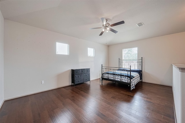 bedroom featuring visible vents, a ceiling fan, and wood-type flooring