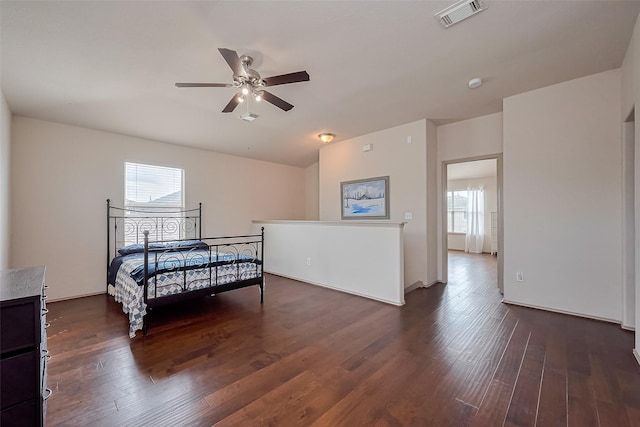 bedroom featuring ceiling fan, visible vents, and dark wood-style floors