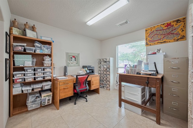 office with visible vents, a textured ceiling, and light tile patterned floors