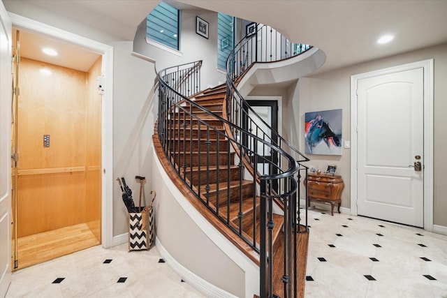 tiled foyer entrance with recessed lighting, baseboards, and stairway