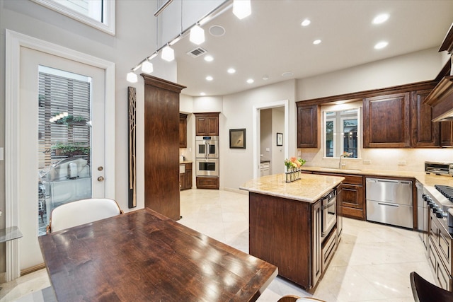 kitchen featuring recessed lighting, dark brown cabinets, visible vents, stainless steel appliances, and a sink