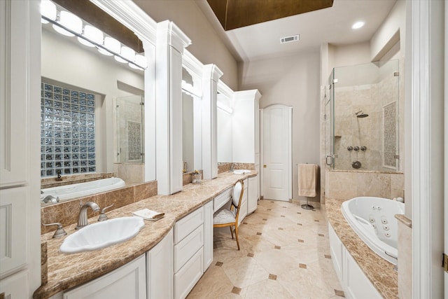 full bathroom with a whirlpool tub, a stall shower, visible vents, and vanity