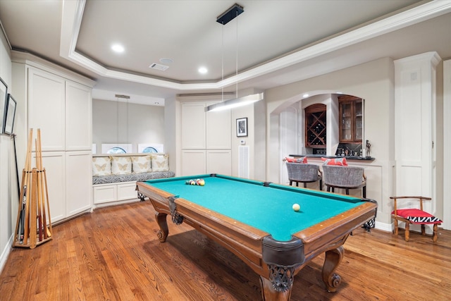 recreation room featuring visible vents, a raised ceiling, a dry bar, light wood-type flooring, and billiards