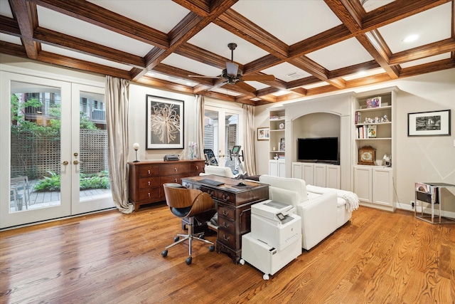 living room with built in features, french doors, light wood-style flooring, a ceiling fan, and beamed ceiling