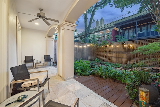 view of patio / terrace featuring fence and a ceiling fan