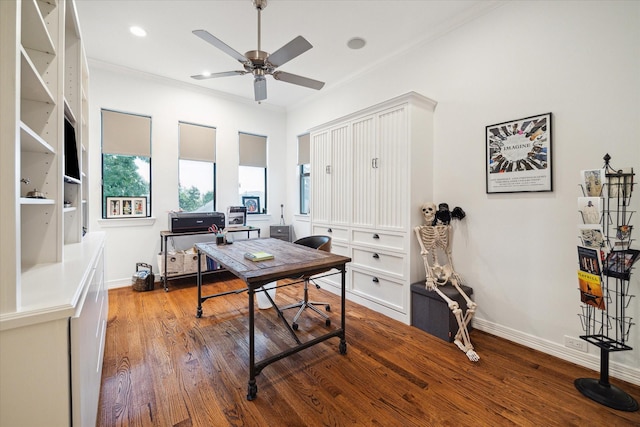 office space with wood finished floors, ornamental molding, baseboards, and a ceiling fan