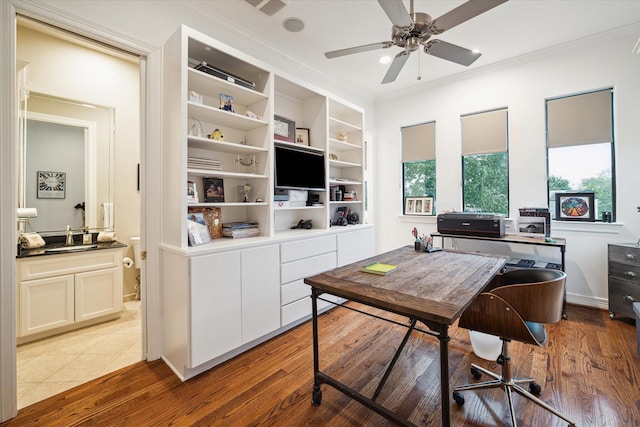home office featuring light wood-style floors, ornamental molding, and ceiling fan