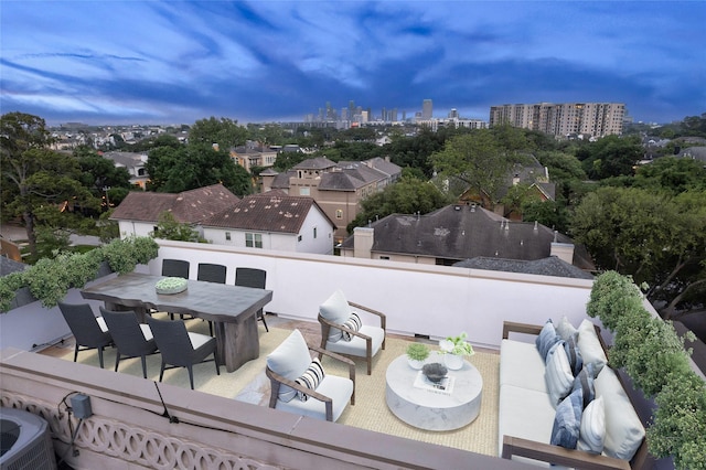 exterior space featuring outdoor dining space, an outdoor hangout area, and a view of city