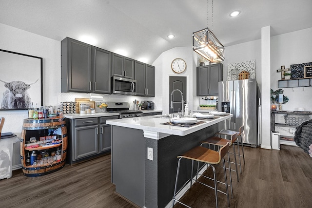 23231 Twilight Oaks Ct, Katy, TX 77493 - kitchen featuring a kitchen breakfast bar, dark wood-style flooring, light countertops, a sink, and stainless steel appliances