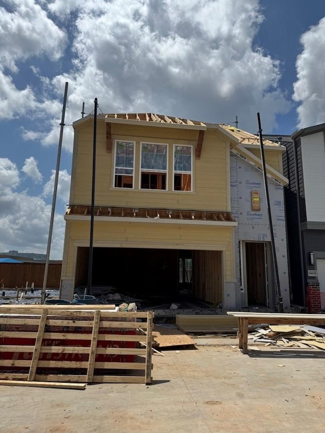 property under construction with fence and an attached garage