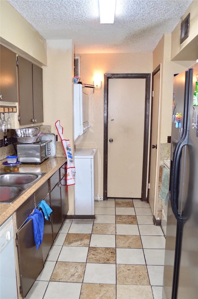 10203 Forum Park Dr Unit 114, Houston, TX 77036 - kitchen featuring freestanding refrigerator, a textured ceiling, light countertops, white dishwasher, and a sink