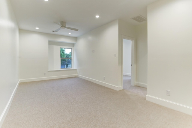 spare room featuring light carpet, a ceiling fan, visible vents, and recessed lighting