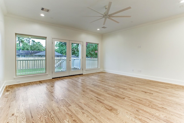 spare room featuring crown molding, french doors, wood finished floors, and a ceiling fan