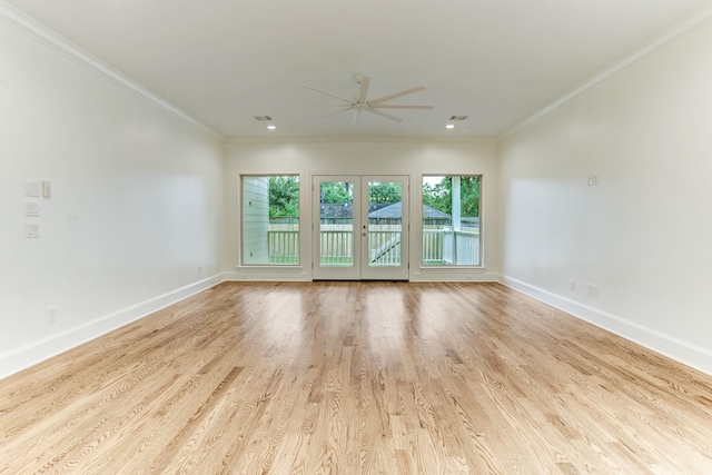 unfurnished room with baseboards, ornamental molding, a ceiling fan, visible vents, and wood finished floors