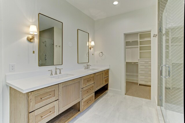 full bath featuring a shower stall, double vanity, and a sink