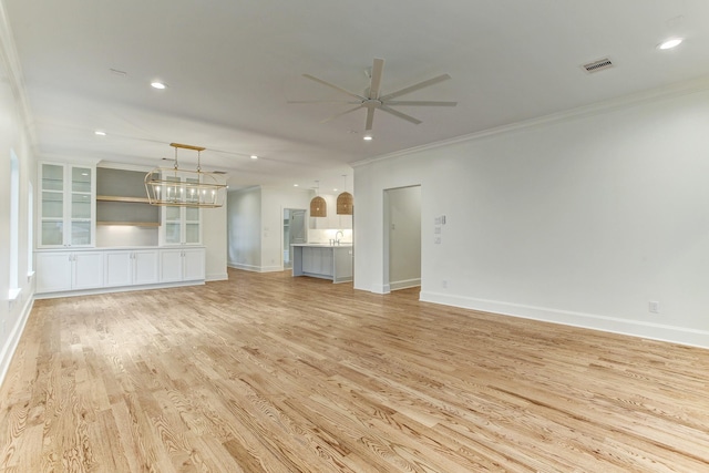unfurnished living room featuring recessed lighting, light wood-style flooring, ornamental molding, and ceiling fan