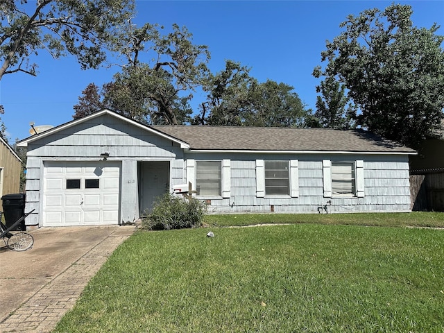 ranch-style house with an attached garage, driveway, and a front lawn
