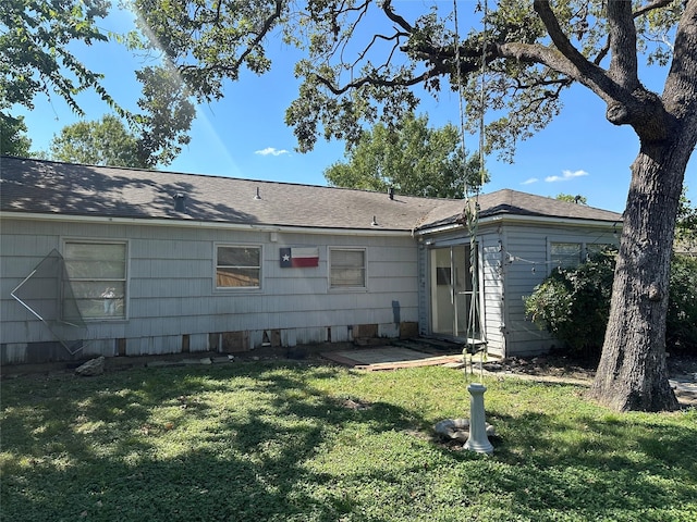 rear view of property with a yard