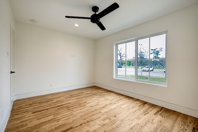 spare room featuring ceiling fan, recessed lighting, wood finished floors, and baseboards