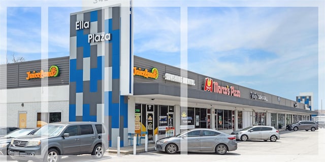 view of building exterior featuring uncovered parking