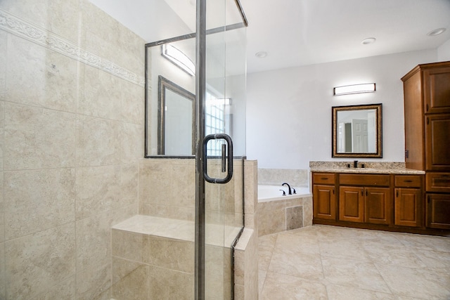 bathroom featuring a shower stall, tile patterned flooring, vanity, and a garden tub
