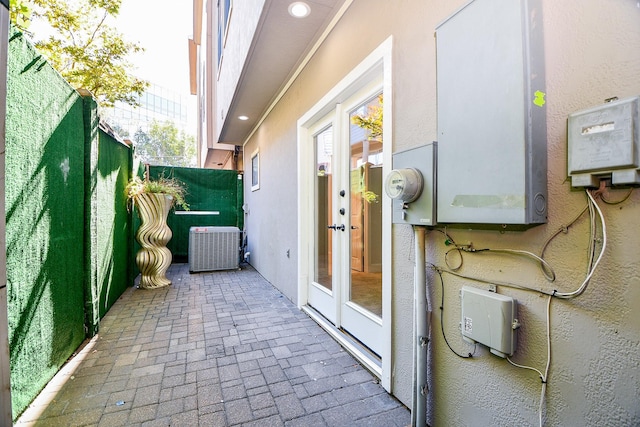 exterior space featuring french doors, a fenced backyard, and central AC unit