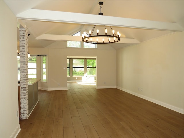 spare room with baseboards, a notable chandelier, and dark wood finished floors