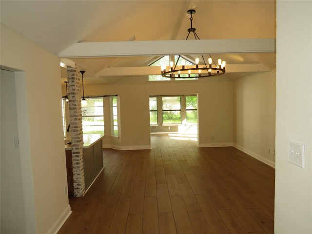 interior space with baseboards, a notable chandelier, and dark wood finished floors