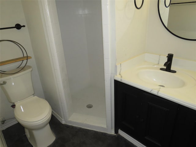 bathroom featuring a stall shower, vanity, and toilet
