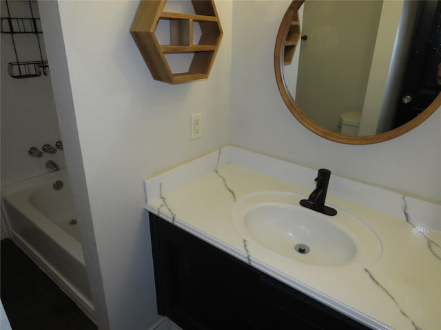 bathroom featuring shower / washtub combination, vanity, and toilet