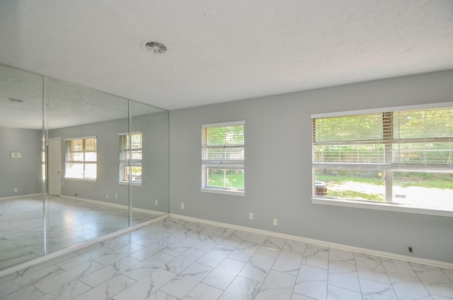 6606 Flamingo Dr, Houston, TX 77087 - unfurnished room featuring a healthy amount of sunlight, marble finish floor, and baseboards