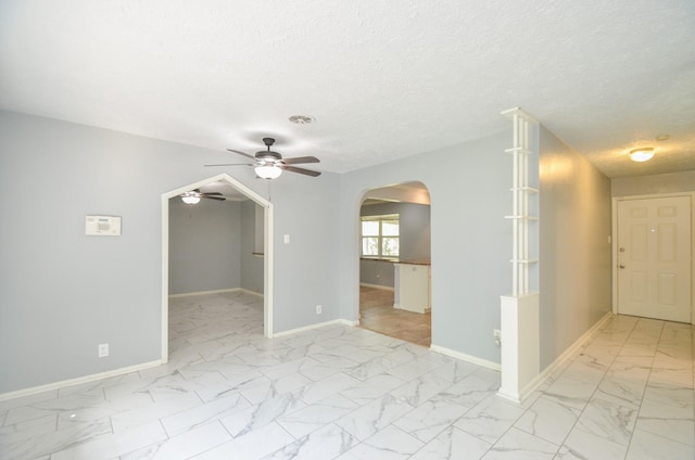 6606 Flamingo Dr, Houston, TX 77087 - unfurnished room with marble finish floor, arched walkways, ceiling fan, and baseboards