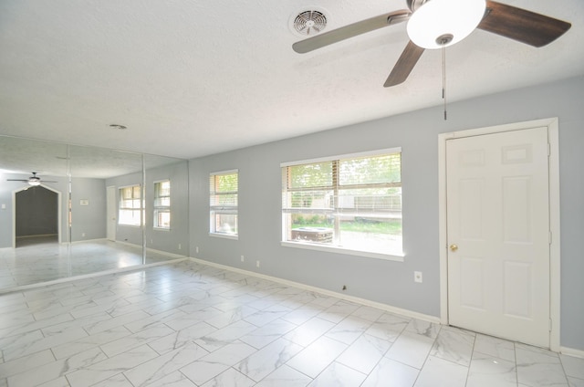6606 Flamingo Dr, Houston, TX 77087 - unfurnished room with visible vents, baseboards, a ceiling fan, a textured ceiling, and marble finish floor