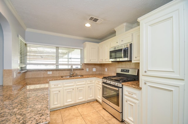 6606 Flamingo Dr, Houston, TX 77087 - kitchen featuring light tile patterned floors, backsplash, visible vents, stainless steel appliances, and a sink