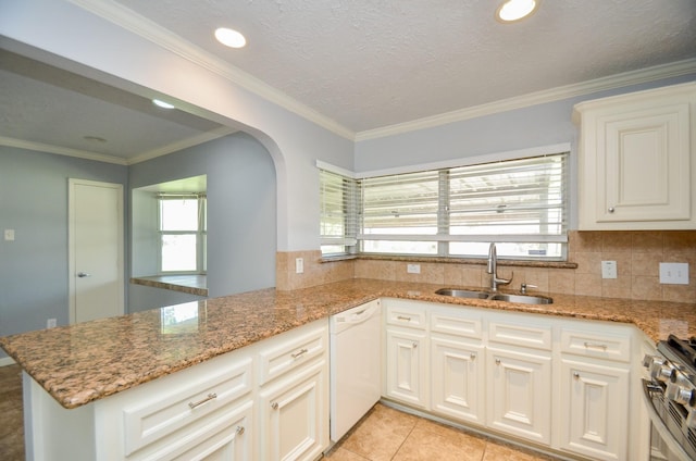 6606 Flamingo Dr, Houston, TX 77087 - kitchen featuring arched walkways, white dishwasher, gas range, a sink, and light stone countertops