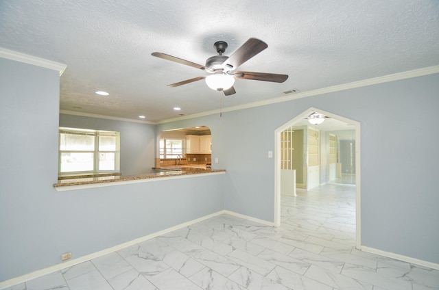 6606 Flamingo Dr, Houston, TX 77087 - empty room featuring arched walkways, ceiling fan, marble finish floor, and baseboards
