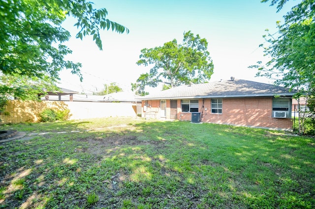 6606 Flamingo Dr, Houston, TX 77087 - back of property featuring central AC unit, a fenced backyard, brick siding, and a yard