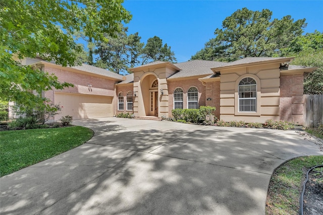 110 Wick Willow Dr, Montgomery, TX 77356 - mediterranean / spanish home featuring brick siding, concrete driveway, a garage, and a shingled roof