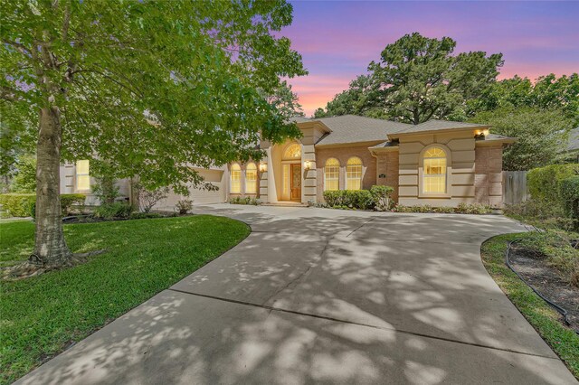 110 Wick Willow Dr, Montgomery, TX 77356 - view of front of home featuring driveway, brick siding, a front yard, an attached garage, and a shingled roof