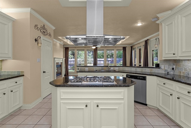 110 Wick Willow Dr, Montgomery, TX 77356 - kitchen with appliances with stainless steel finishes, island exhaust hood, light tile patterned floors, a sink, and crown molding