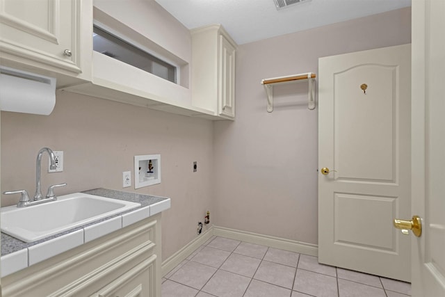 110 Wick Willow Dr, Montgomery, TX 77356 - washroom featuring electric dryer hookup, washer hookup, cabinet space, light tile patterned floors, and baseboards