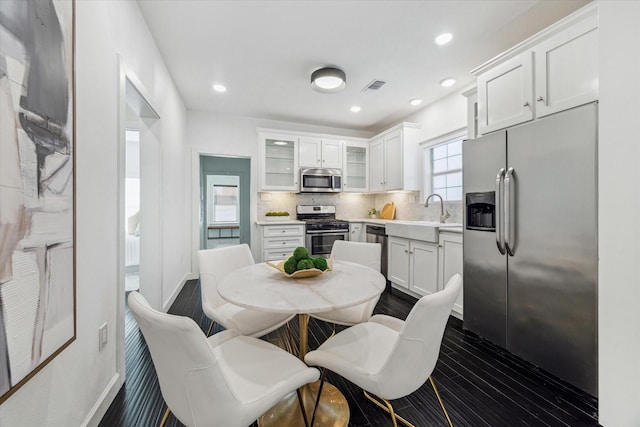 1505 Bonner St, Houston, TX 77007 - kitchen featuring a sink, visible vents, white cabinetry, and stainless steel appliances