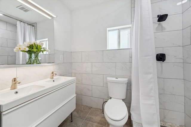 1505 Bonner St, Houston, TX 77007 - bathroom with a sink, visible vents, and tile walls