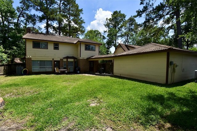 rear view of property featuring a chimney and brick siding