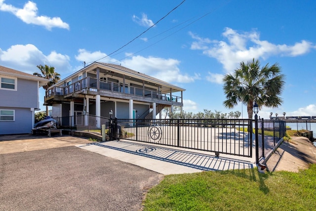 view of front of property featuring a balcony and a fenced front yard